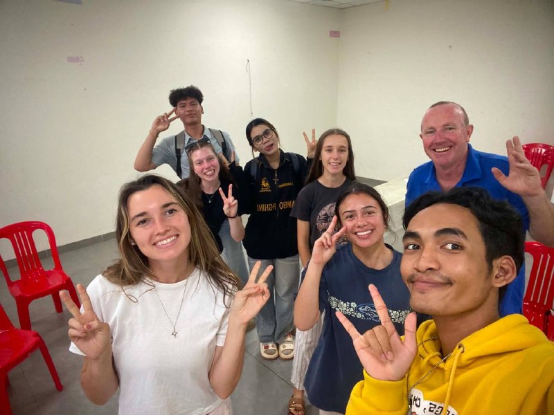 Brieya and a group of young adult ministry teammates posing together indoors.