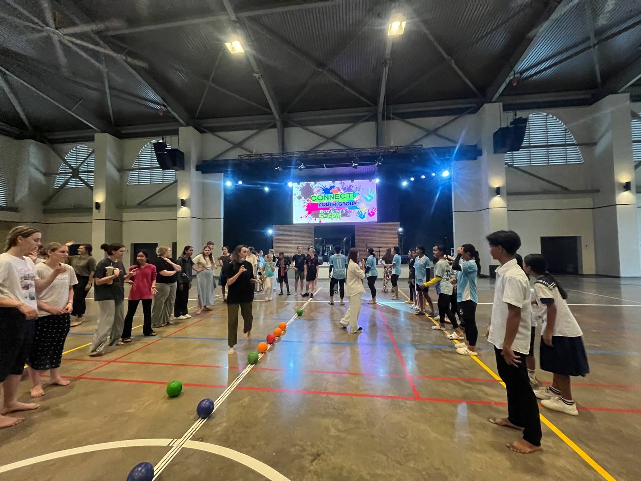 A large group playing an activity game together during a youth group night.